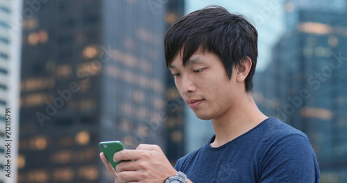 Photography Man look at smart phone at outdoor park