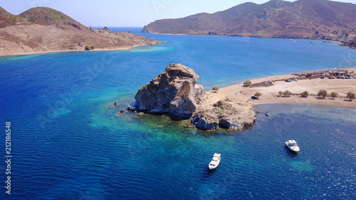 Aerial birds eye view photo taken by drone of famous rock of Kalikatsou in Petra beach, Patmos island, Dodecanese, Greece photo