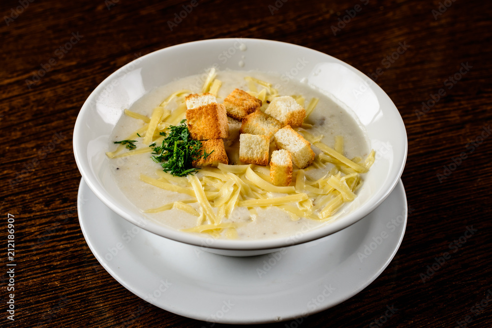 Cheese soup. Delicious soup with cheese and croutons in the whit Cheese soup. Delicious soup with cheese and croutons in the whit