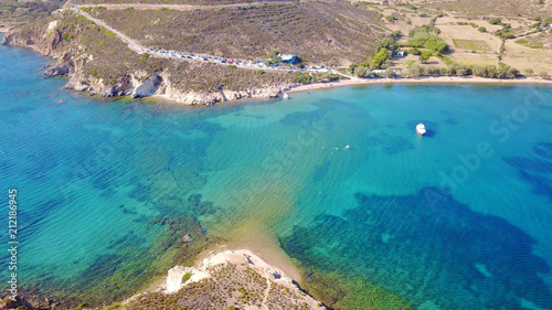 Aerial bird's eye view photo taken by drone of famous rocky beach of Livadi Geranou with turquoise clear waters, Patmos island, Greece