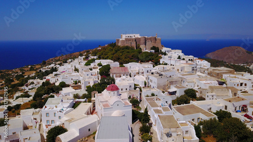 Aerial bird's eye view photo taken by drone of massive fortified stone Monastery of Saint John the Apostle with views to Aegean sea, Patmos island, Greece