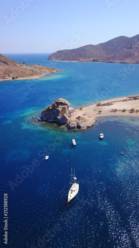 Aerial birds eye view photo taken by drone of famous rock of Kalikatsou in Petra beach, Patmos island, Dodecanese, Greece photo
