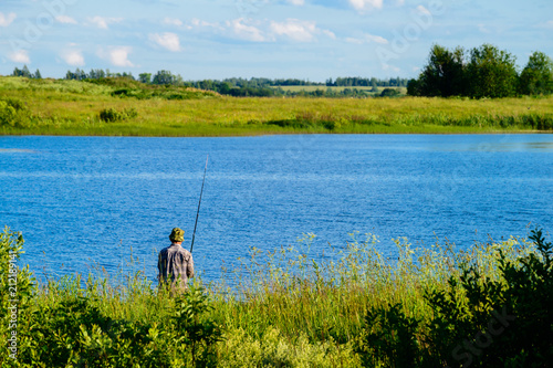 Unidentified man fishing on the lake