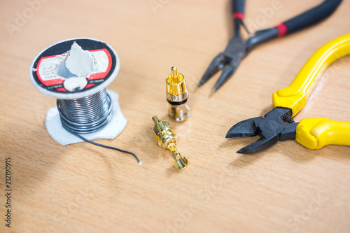 Repair and adjustment of the equipment, the RCA cable and pliers .on the table