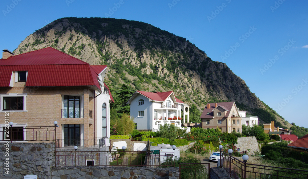 HURZUF, CRIMEA - June, 2018: View of the cottages in Gurzuf on the background of Ayu-Dag (Bear mountain)