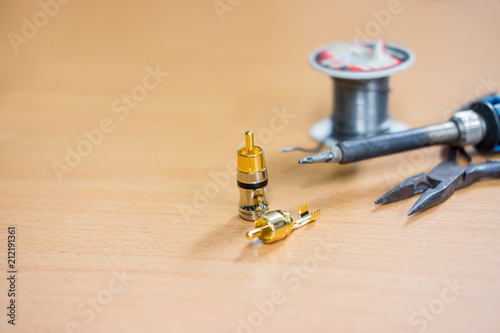 Closeup of soldering RCA cable, Repair and adjustment of the equipment, the RCA cable and pliers .on the table