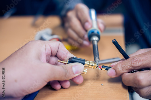 Closeup of soldering RCA cable, Repair and adjustment of the equipment, the RCA cable and pliers on the table