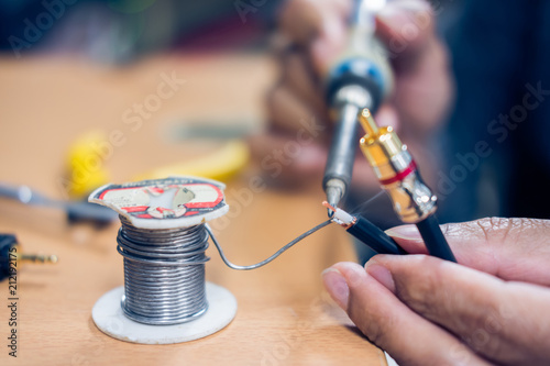 Closeup of soldering RCA cable, Repair and adjustment of the equipment on the table