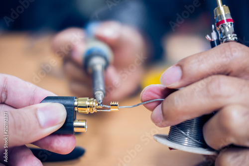 Closeup of soldering RCA cable, Repair and adjustment of the equipment, the RCA cable and pliers on the table