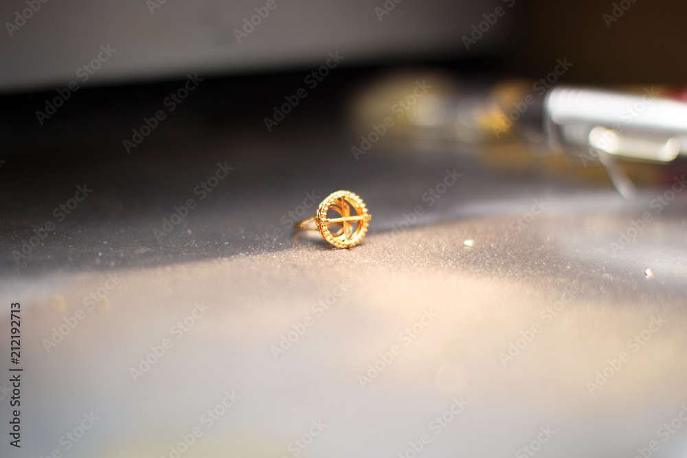 Gold ring with dust on the industrial table Gold ring with dust on the industrial table