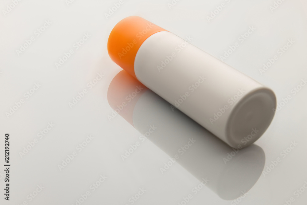 white bottle of suntan cream lies on white background white bottle of suntan cream lies on white background