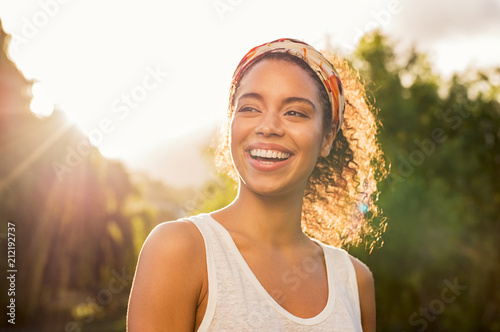 Young african woman smiling at sunset photo