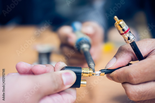 Closeup of soldering RCA cable, Repair and adjustment of the equipment, the RCA cable and pliers on the table