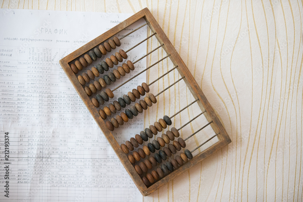Wooden abacus on the wall with paper chart Wooden abacus on the wall with paper chart