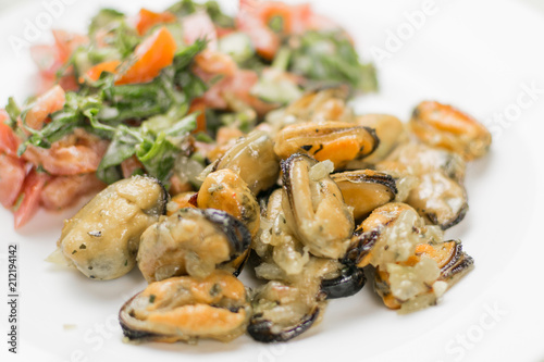Fried mussels with fresh vegetable salad.
