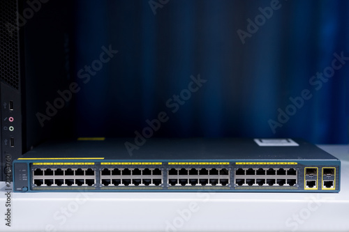 48 port fast network switch front view on the dark background, Used in data center. networking concept and Information technology.