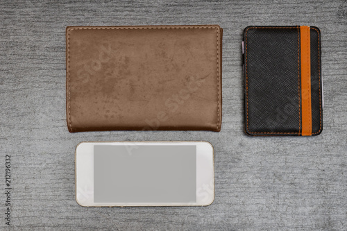 Smartphone, wallet and passport on a black table. Top view