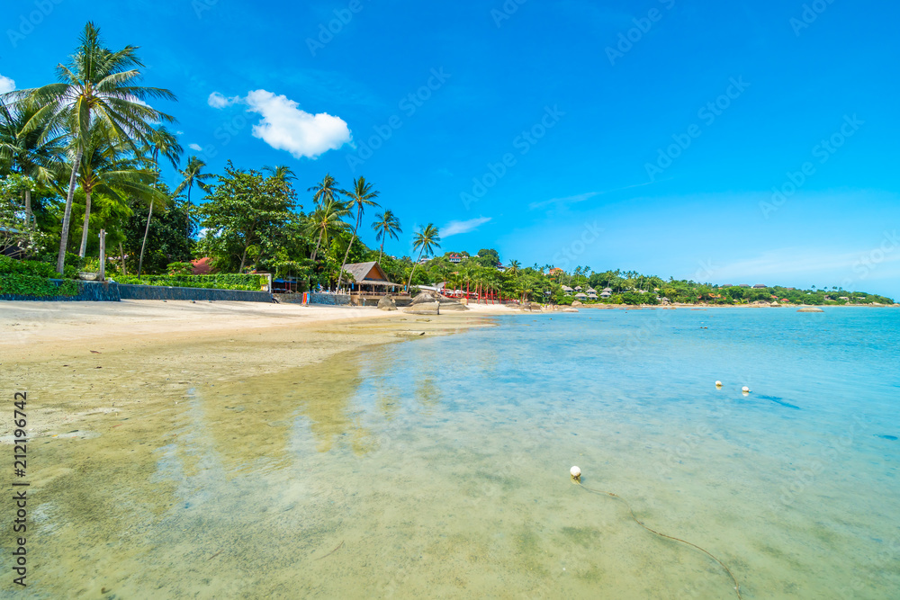 Beautiful tropical beach sea and sand with coconut palm tree on blue sky and white cloud Beautiful tropical beach sea and sand with coconut palm tree on blue sky and white cloud