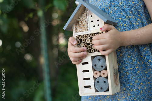 Green schooling. Girl holding insect hotel © rasstock