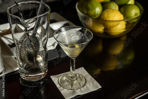 martini glass and mixer on a bar.