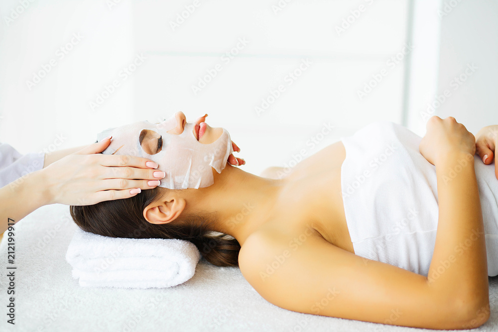 Obraz premium Beauty. Woman in the Beauty Salon with Mask for Face. Lying on the Massage Tables with Closed Eyes. Clean and Fresh Skin. Skin Care. High Resolution