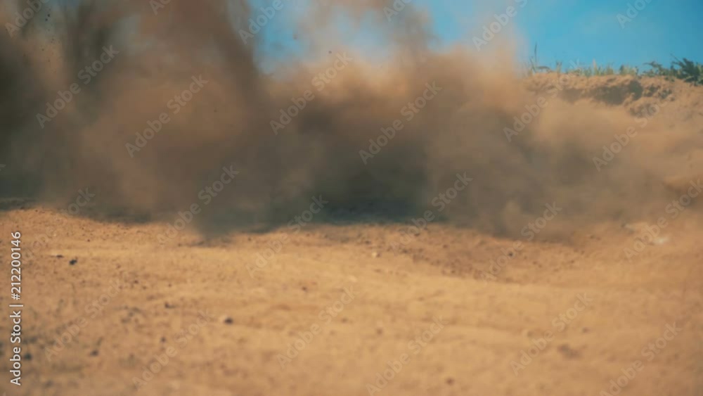 Clouds of dirt raised after high-speed passing of a sportbike Clouds of dirt raised after high-speed passing of a sportbike