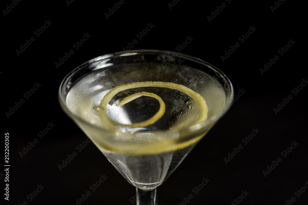 Classic glass of dry Martini with olive and with a lemon twist, close-up. Classic glass of dry Martini with olive and with a lemon twist, close-up.