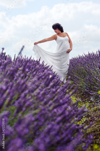 Fototapeta Naklejka Na Ścianę i Meble -  Portrait of pregnant woman in fairy field of lavender.