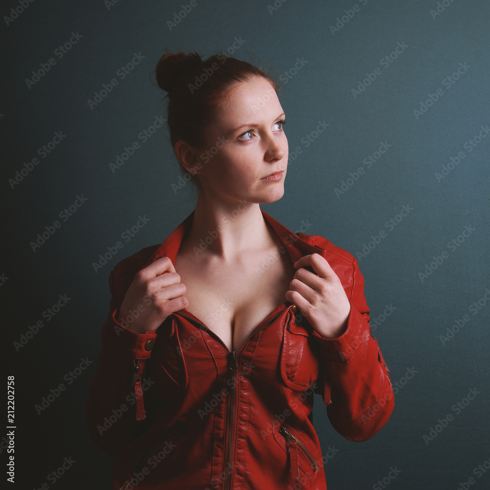 perky young busty woman wearing red vintage leather jacket showing cleavage  Stock Photo | Adobe Stock