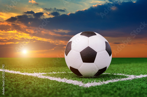 soccer ball on soccer field at sunset.