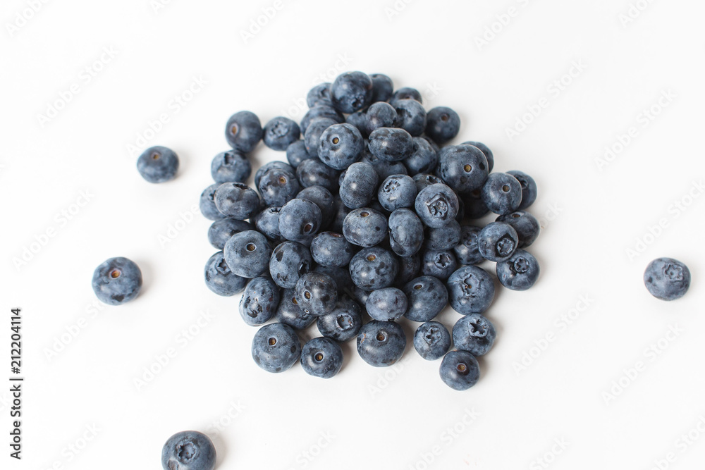 Handful of large blueberries on white background