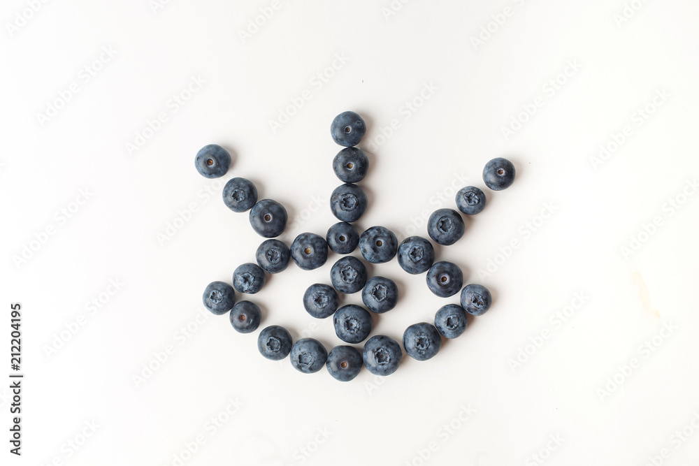 Eye with three eyelashes of blueberries on white background Eye with three eyelashes of blueberries on white background