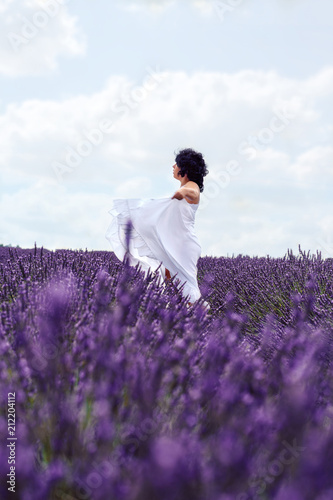 Celebrating the beauty of life- Happy pregnant woman on lavender field .
