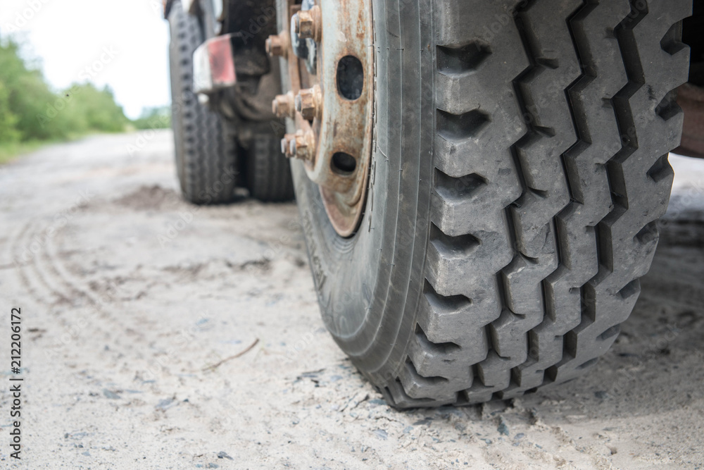 Truck in the sand, wheel close-up, construction. Traces from the truck on the sand. Truck in the sand, wheel close-up, construction. Traces from the truck on the sand.