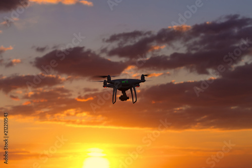 flying drone on the background of a beautiful sunset / beautiful sky drone doing its job