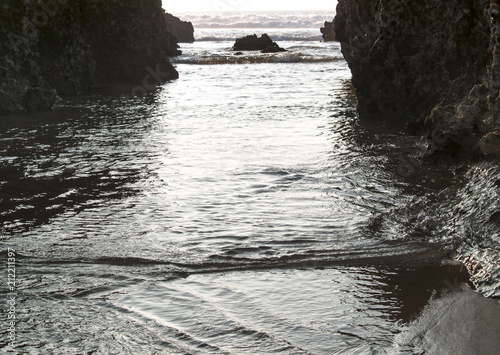 Olas entrando entre las rocas de la playa de Liencres photo