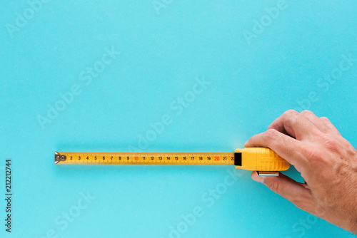 Handyman measuring size with tape meter photo