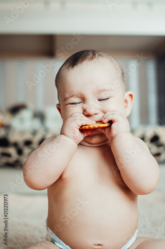 adorable baby eating a cookie photo