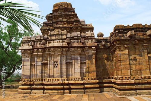 Dravidian vimana style sikhara and a view of the Devakoshthas on the south wall. Jain temple, Jinalaya, known as Jaina Narayana, Pattadakal, Karnataka. Southwest view. photo