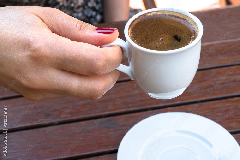 A Woman Holding a Cup of Turkish Coffee A Woman Holding a Cup of Turkish Coffee