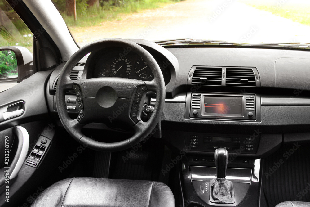 View of the interior of a modern automobile showing the dashboard. Black leather car interior