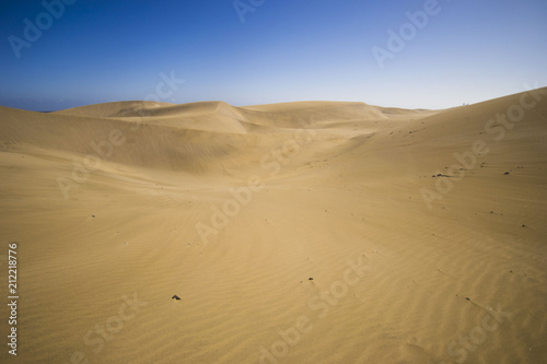 minimalistic view of sand dunes landscape  minimalism in nature  sand everywhere and windy weather  shapes and creations
