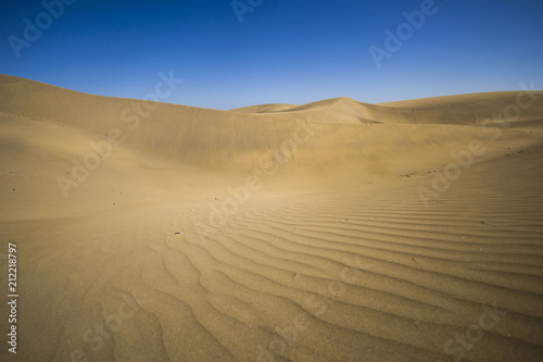minimalistic view of sand dunes landscape  minimalism in nature  sand everywhere and windy weather  shapes and creations