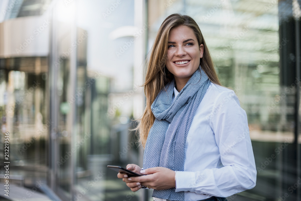 Portrait of smiling young businesswoman with smartphone Portrait of smiling young businesswoman with smartphone