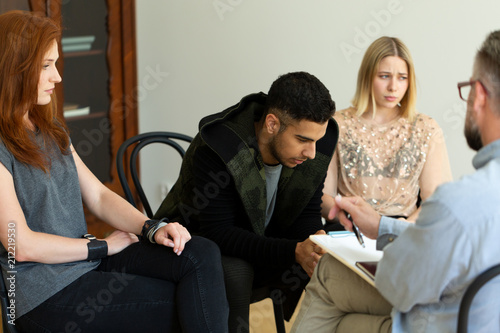Photography Close-up of a sad hispanic man talking to his therapist about depression and sui