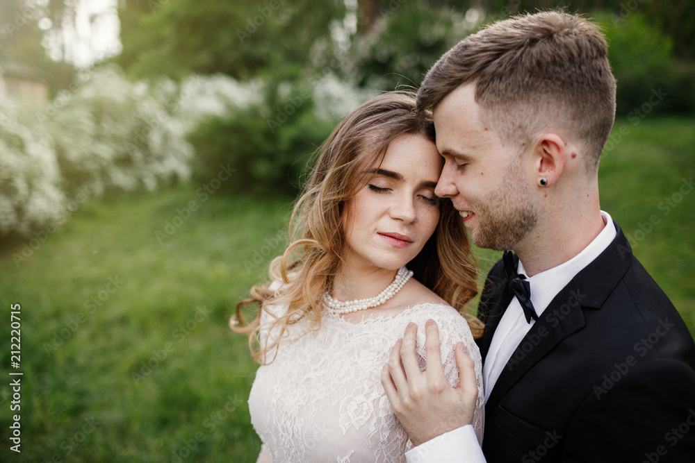 Elegant gorgeous bride and stylish groom posing in the park. Elegant gorgeous bride and stylish groom posing in the park.