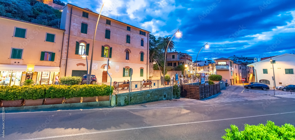 CASTIGLIONE DELLA PESCAIA, ITALY - JUNE 12, 2018: City center with tourists and homes on a summer night. This is a famous tourist destination in Tuscany