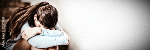 Foto Sad schoolgirl sitting alone on staircase