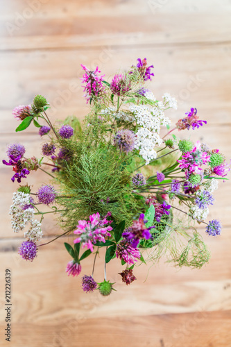 Home made Fresh Wild Flowers Bouquet on Wooden Table.