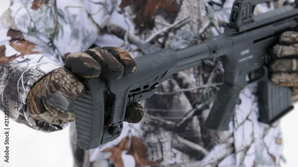 Close-up view of tactical gun. Man's hand hold a gun and show butt ...